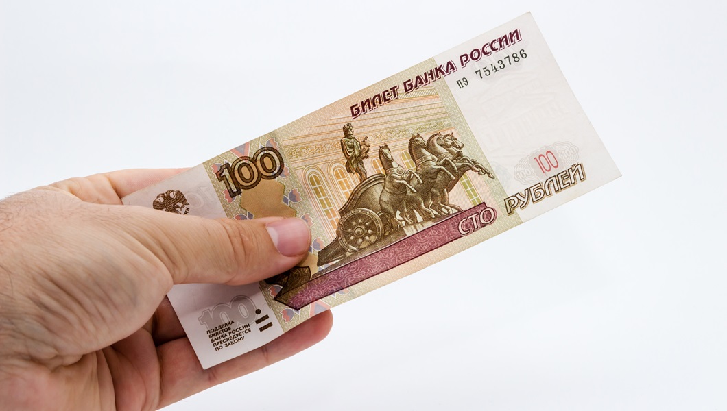 Closeup shot of a person holding some cash over a white background