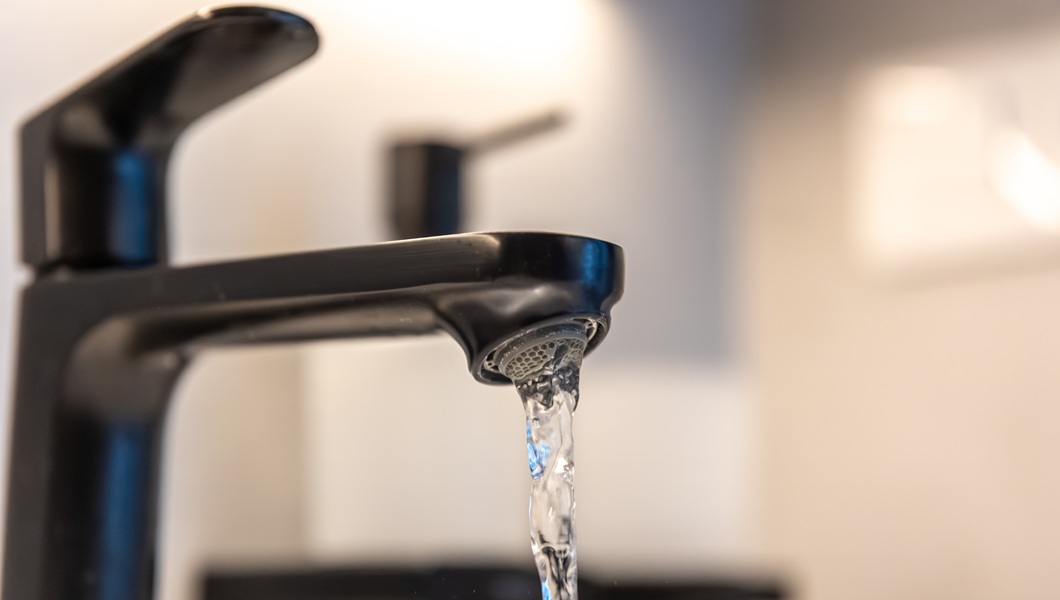 Black tap macro. Water flow. Minimal aesthetic