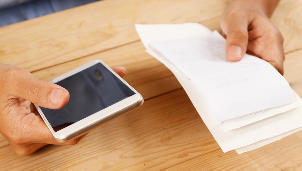 Closeup of woman calculating or paying bills
