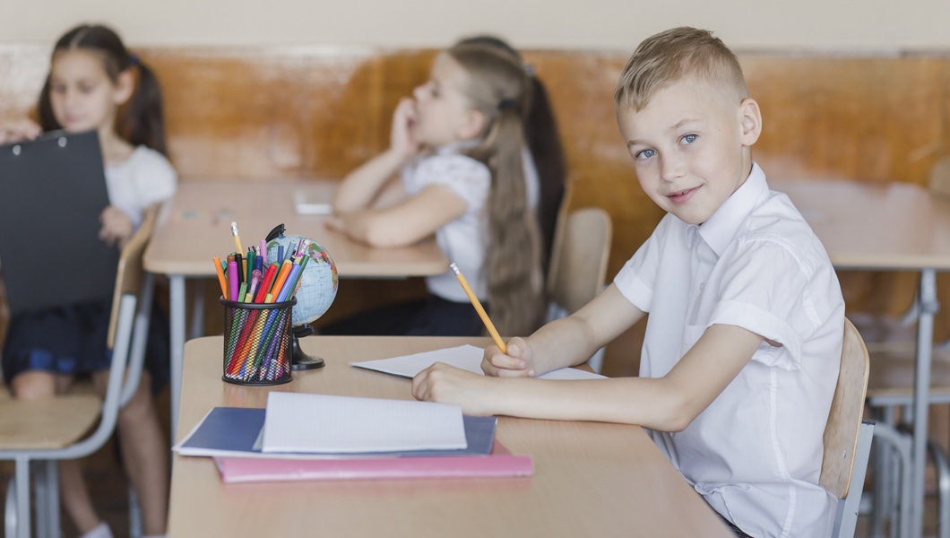 boy-sitting-classroom-writing