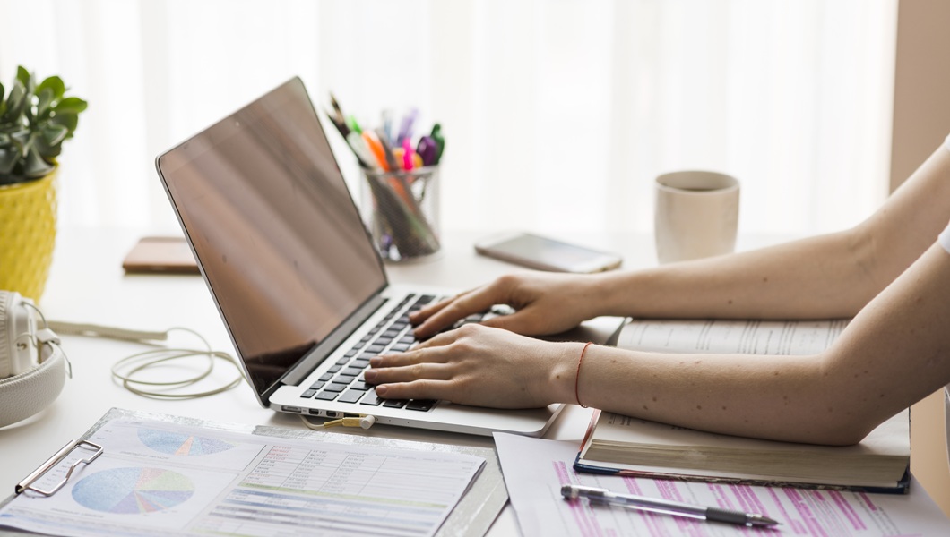 crop-hands-using-laptop-office