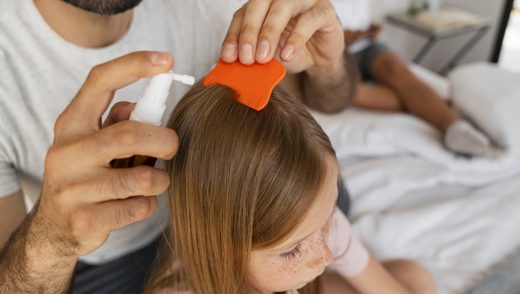 high-angle-father-using-lice-treatment-comb