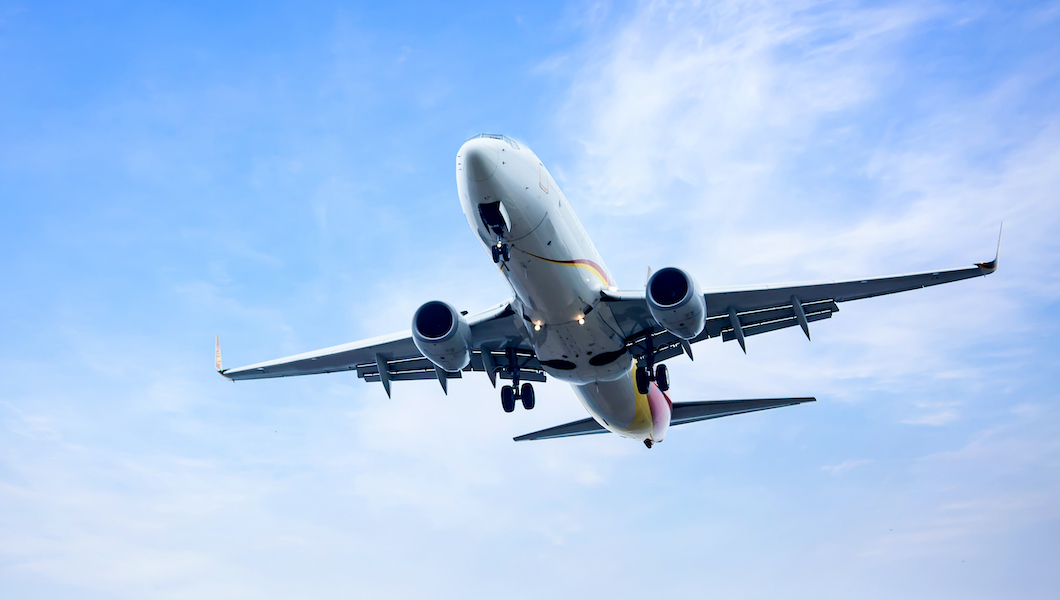 Place flying in sunset sky