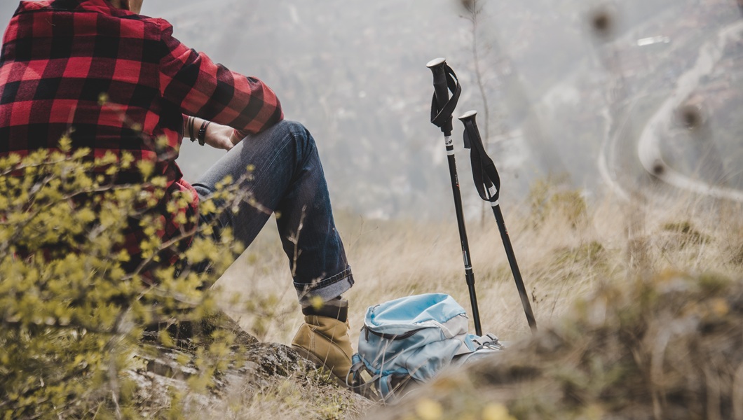 rambler-sitting-his-backpack-his-walking-sticks