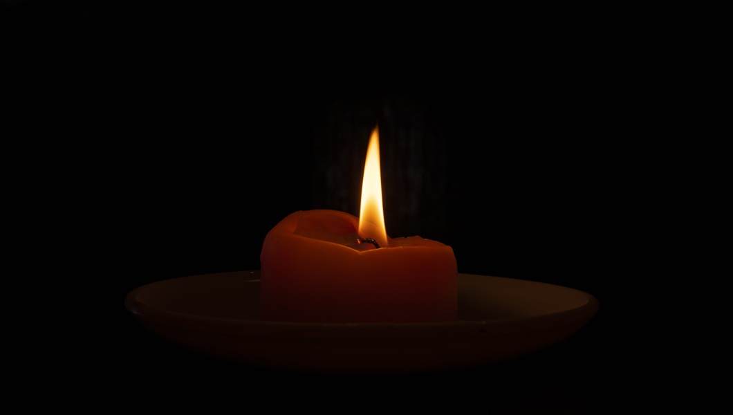Closeup shot of a burning candle in the dark
